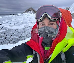 A self captured image of Billy that displays her heavily covered face and a view of the forming Sea ice in its current early forming state of 'pancake Ice'