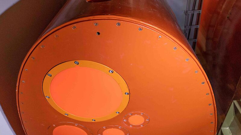 A large orange metal keel housed inside a ship