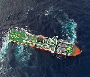 Looking from above directly down on to a ship.  Trails in the water show that the ship is turning in a circle in the water
