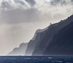 An atmospheric shot of island cliffs falling to the sea.