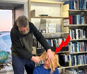 An expeditioner helps with a wig during WIFFA filming at Mawson recently