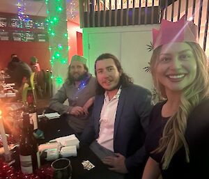a self captured image of expeditioners at the table during Christmas festivities