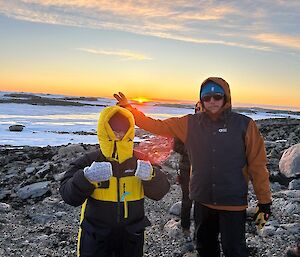 a view of a sunny background horizon with expeditioners in the foreground seeing the year out and welcoming the new year in