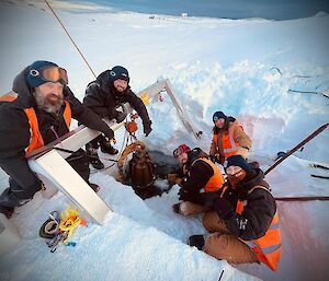 5 trades personnel are captured during a team effort of a replacement component to the melt bell, a piece of infrastructure that melts ice water