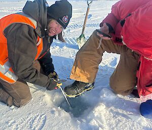 Fitzy and Tom measuring the sea ice thickness