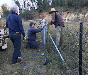 An image of James and family out in the land doing fence work