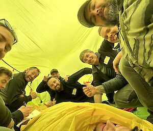 A self captured image of James and newly met Antarctic work crew under a group bivvy, a large fabric dome used to shelter out of the wind