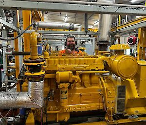 James inside the Main Power House gives a thumbs up with a large smile after installing the new CAT engine