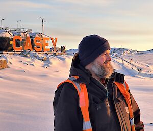 James standing in the foreground gazing into the bay with the Casey sign in the background