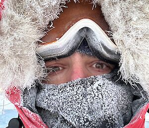 a self captured image of James with white frost around his face and head wear