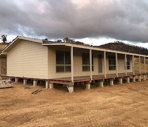 A photo of James' uncle newly built home after it previously burnt down home. a large verandah and timber deck.