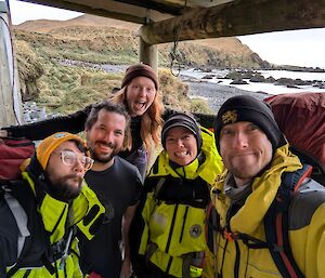 Selfie of five expeditioners on porch of field hut