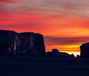 A beautiful orange-red sunset captured Auster with the icebergs silhouetted in the foreground