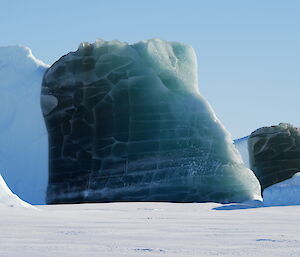 An iceberg - half of which is a rich deep green/blue colour - in Antarctica they are the elusive and highly prized jade bergs