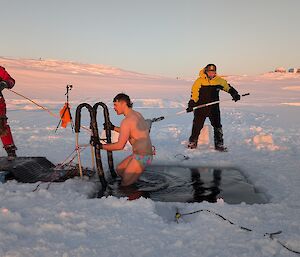 an expeditioner vacates out of the open sea ice cold water plunge during the mid-winters swim