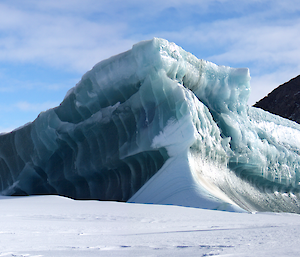 A jade-coloured iceberg in the sea ice near the Colbeck Archipelago to the west of Mawson