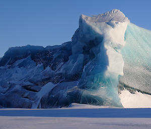 An unusual shaped jade-coloured iceberg in the sea ice to the west of Mawson