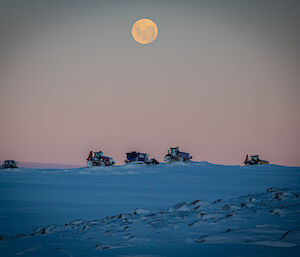 An ethereal moon brooding over the dreary landscape, vehicles parked in the mid-ground repress the otherwise reclusive scenery.