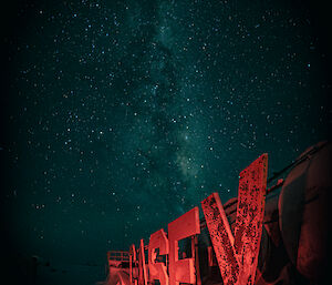 a luminous array of stars backdrops an artificially lit Casey sign during a winters gloom.