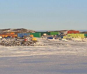 A wide shot of Davis station with red, blue and green metal buildings