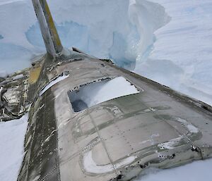 A close up of the Russian aircraft wreck in the plateau ice with lettering still visible on the fuselage