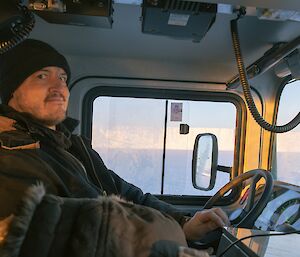 Mark Whapham driving a Hagglunds tracked vehicle on the sea ice near Mawson station recently