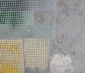 Looking down on patchwork of walkways around station - yellow and green fiber reinforced plastic, concrete and sand
