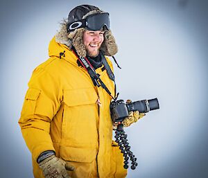 Expeditioner Owen is photographed in awe as he observes the local seal pups
