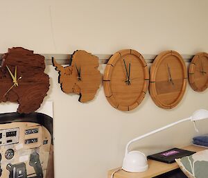5 timber constructed clocks hang in expeditioner room