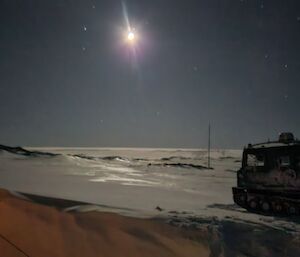 a view of a bright moon Illuminating the sky at Wilkes Hut