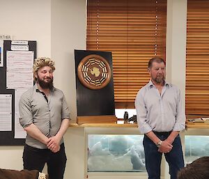 Expeditioners Terry & Nick presenting the timber and brass winter plaque to the 77th ANARE Wintering Team.