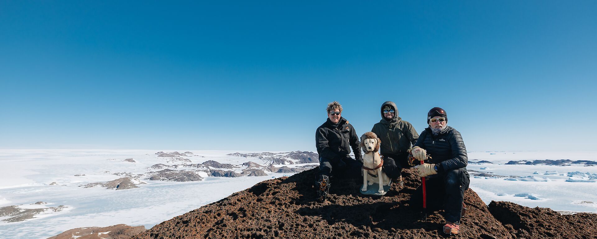 Expeditioners and Stay take a break and the sights at the summit of Ufs Island to the west of Mawson
