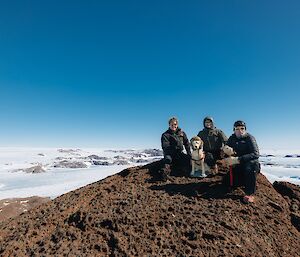 Expeditioners and Stay take a break and the sights at the summit of Ufs Island to the west of Mawson