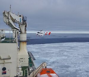 BK helicopter inbound to the Nuyina for landing