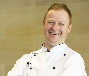 Professional portrait shot of Ultan in his white chef's coat.