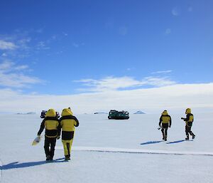 A Cleaner Antarctica and the seabird researchers headin back to the Hagglunds with penguin poo from the Auster emperor colony on the sea ice