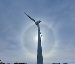 A halo around the sun with the wind turbine in the centre at Mawson station recently