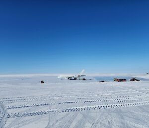 Plane on ice runway with blue sky background
