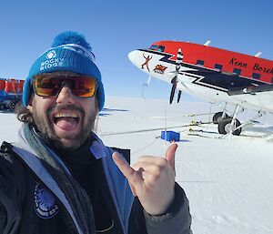 Rob standing in front of plane on ice runwat