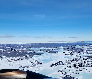 Looking out the window from plane down to the ground below