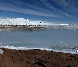 icy landscape with a lake in the background