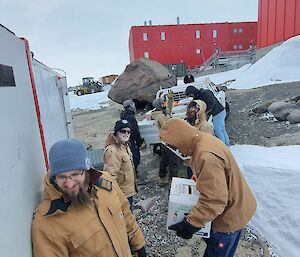 The trades team helping to sort boxes of past it vegetables into the ute