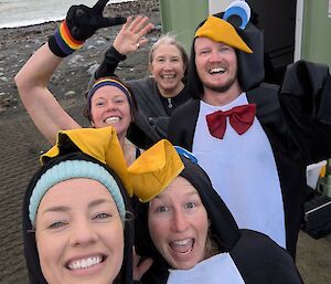 A group of people dressed up like penguins