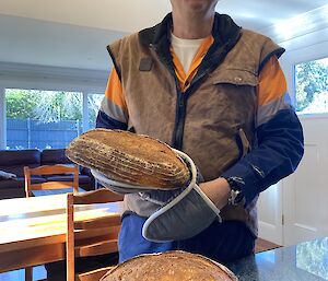 Geoff Wallace, an electrician this year at Casey, eating Jan's sourdough back at their place