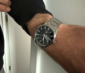 An expeditioners arm wearing a watch