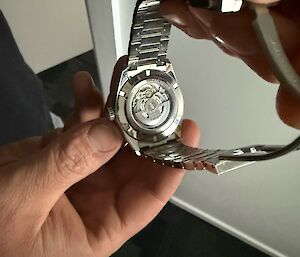 An expeditioners shows the back of the watch, there is a clear back to the watch which reveals the inner workings.