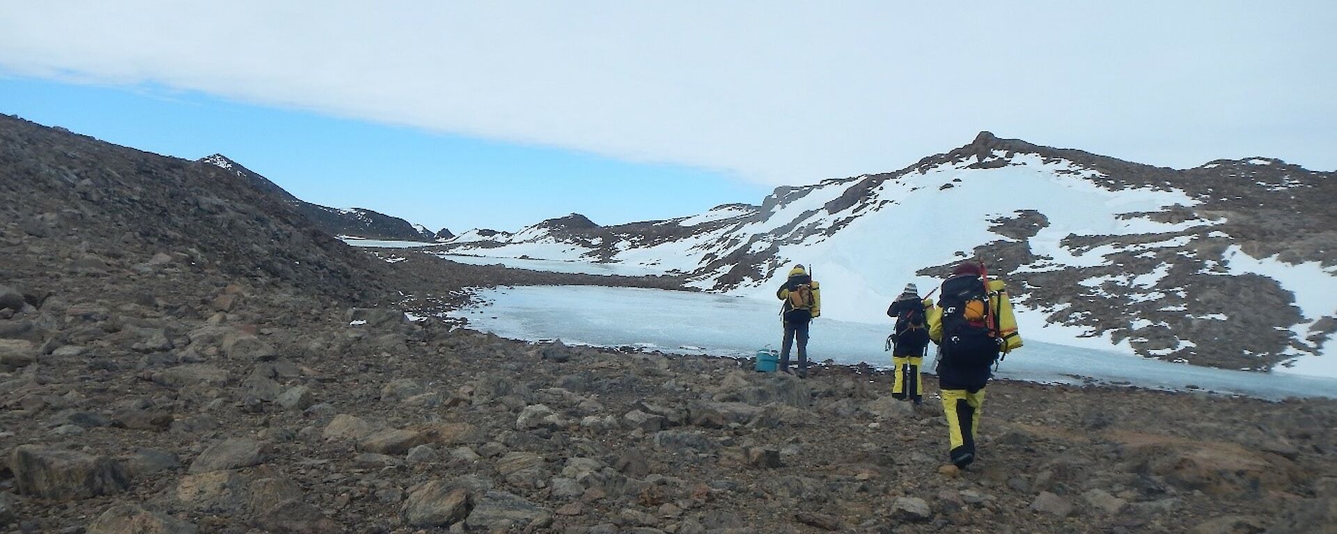 Three expeditioners at Byrd Head, a rocky headland southeast of the Colbeck Archipelago, west of Howard Bay on the Mawson Coast