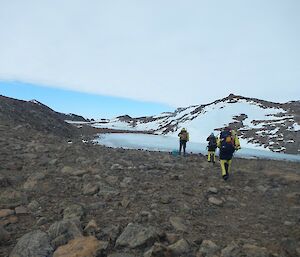 Three expeditioners at Byrd Head, a rocky headland southeast of the Colbeck Archipelago, west of Howard Bay on the Mawson Coast