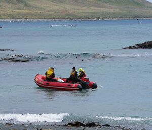Inflatable rubber boat with three crew is just offshore in nice calm waters