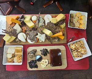 A huge cheese platter with dried fruits and fruit pastes
